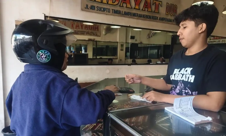 Seorang pelanggan melakukan transaksi pembelian emas di salah satu toko emas di kawasan Ampenan, Kota Mataram.